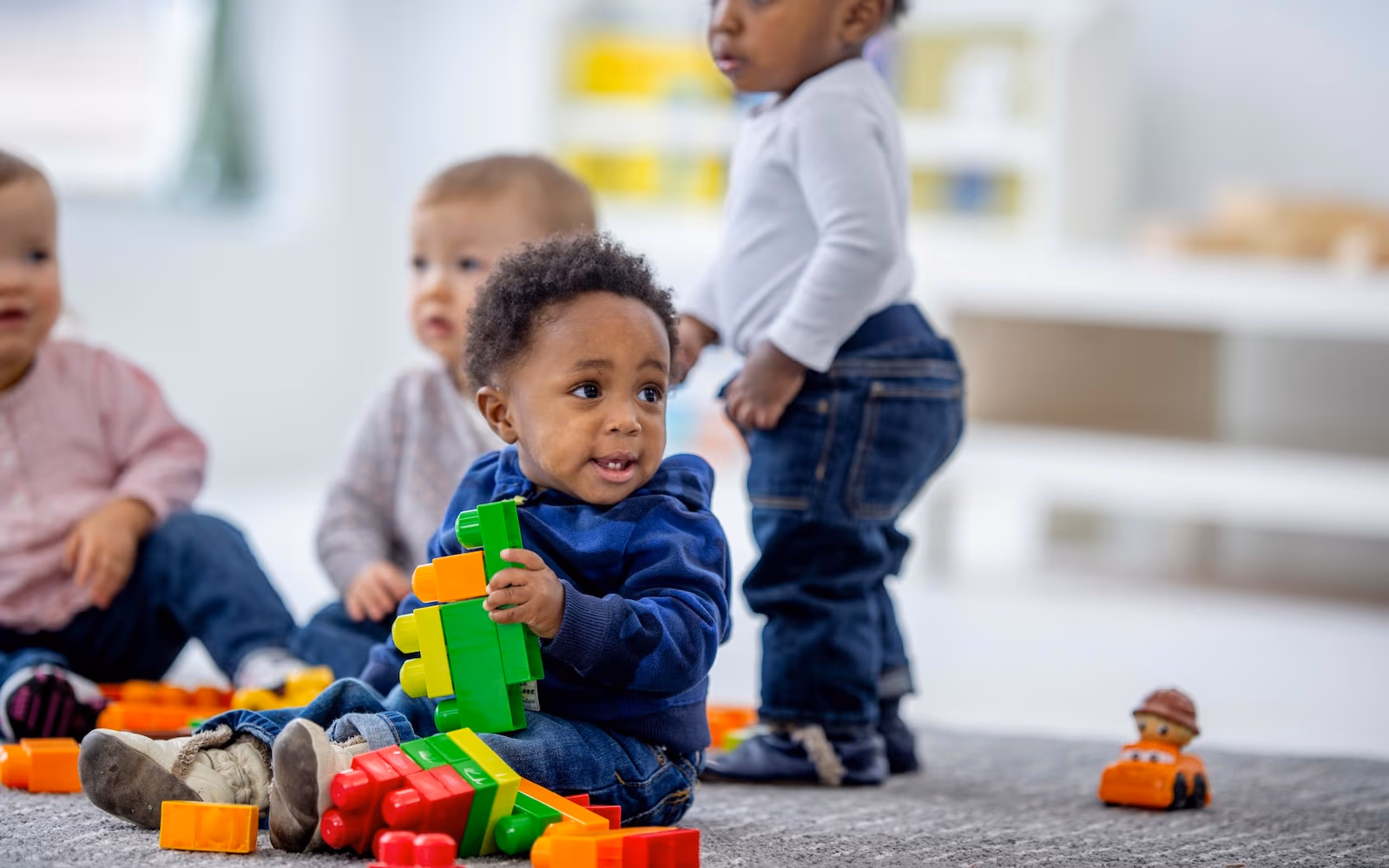 Infants playing together in the New Life Early Learning Academy infant classroom