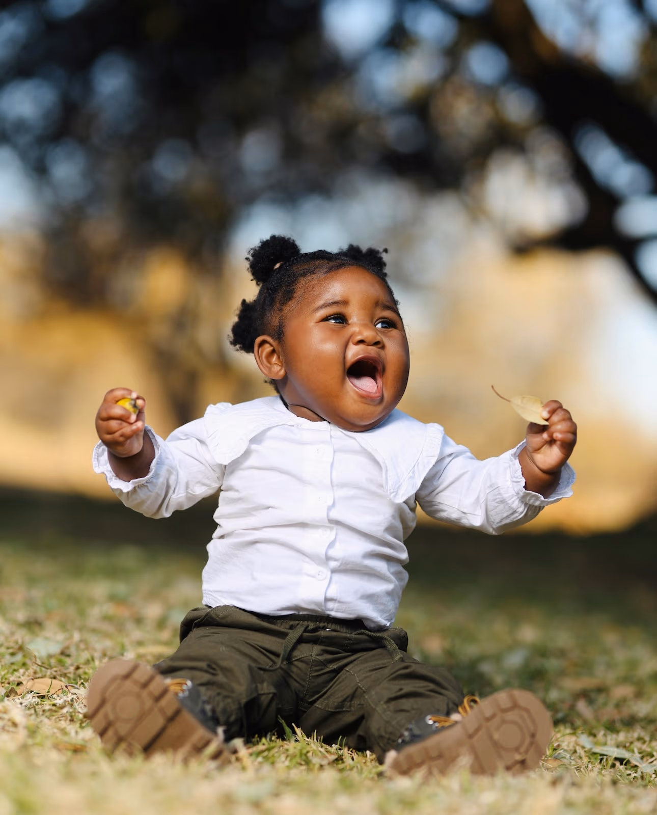 Happy infant playing outdoors at New Life Early Learning Academy